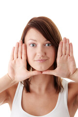 Casual caucasian young woman framing her face with her hands isolated on white background