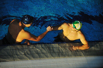 win competiotion and swimming race concept with two freiend who handshaking in pool