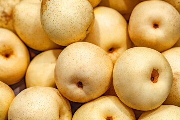 Apples golden in bulk on market, selective focus