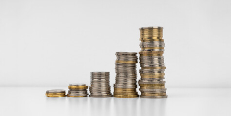 Stacks of coins on a white background