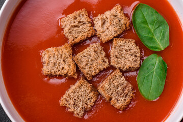 Delicious fresh gazpacho with breadcrumbs, salt and spices in a ceramic plate