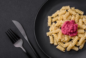 Delicious fusilli pasta with beetroot pesto, parmesan, salt and spices