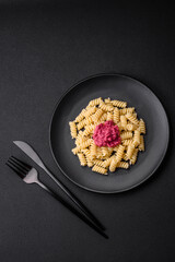 Delicious fusilli pasta with beetroot pesto, parmesan, salt and spices
