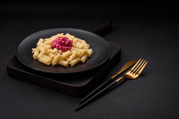 Delicious fusilli pasta with beetroot pesto, parmesan, salt and spices