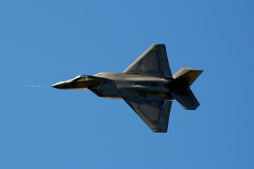 Fototapeta na wymiar fighter jet soaring through a clear blue sky Generative AI