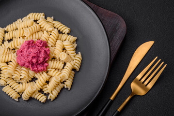 Delicious fusilli pasta with beetroot pesto, parmesan, salt and spices