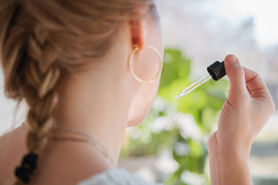 Taking a Dropper of CBD Oil