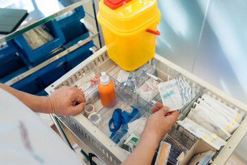 Doctor grabbing a sterile line from a drawer