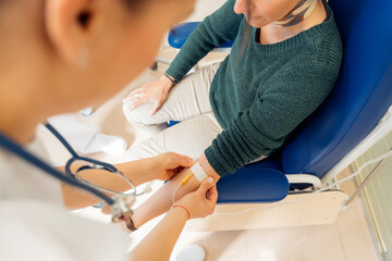 Anonymous doctor drawing blood from patient