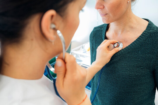 Doctor listening a patient with stethoscope