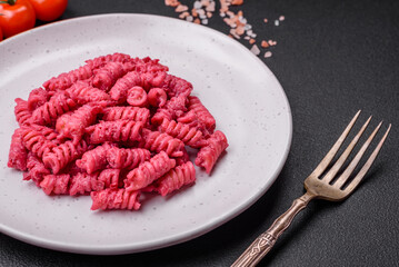 Delicious fusilli pasta with beetroot pesto, parmesan, salt and spices