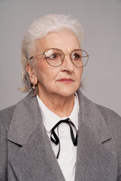 Portrait of a fashionable senior woman in trendy glasses