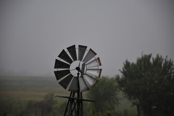 Windmill in a Foggy Field