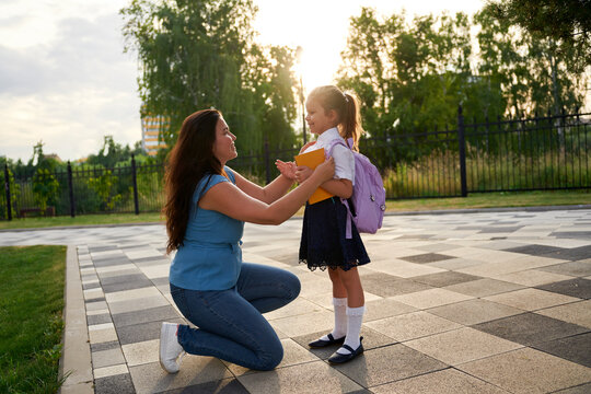 Girl Holds Her Mother's Hand On The First Day Of School