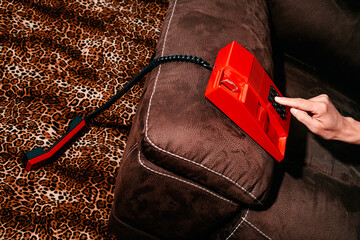 man dials in a retro red landline telephone