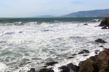Fototapeta na wymiar Watching the waves at Lands End in San Francisco