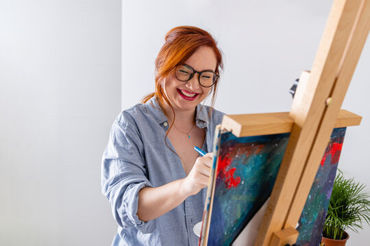 Woman painting on a canvas. 