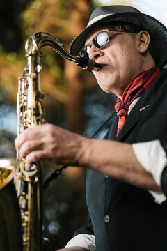 Man playing saxophone during rehearsal outdoors
