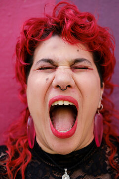 Person with funky hair yelling with open mouth