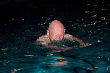 Elderly man swimming
