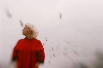 Blur portrait of a woman wearing red coat