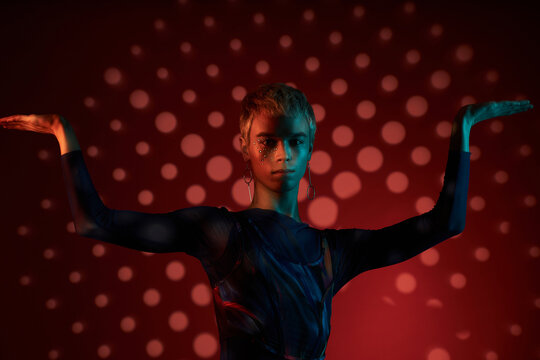 Queer Man Posing In Dark Studio