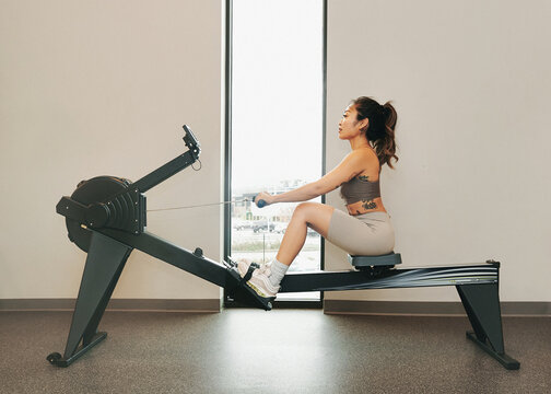 Female on Rowing Machine In The Gym
