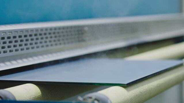 The glass goes into the machine on rollers and goes through the tempering process