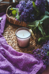 Obraz na płótnie Canvas Candle and lilac in home interior