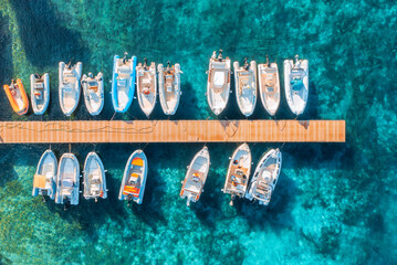 Aerial view of boats and luxure yachts in dock at sunset in summer in Sardinia, Italy. Colorful...