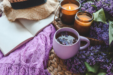 Cup of hot tea and lilac bouquet, good morning concept