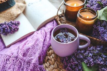 Cup of hot tea and lilac bouquet, good morning concept