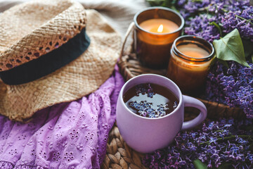 Cup of hot tea and lilac bouquet, good morning concept
