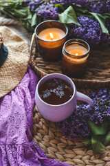 Cup of hot tea and lilac bouquet, good morning concept