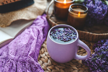 Cup of hot tea and lilac bouquet, good morning concept
