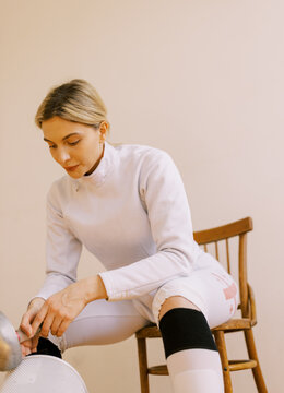 portrait of young woman with fencing uniform