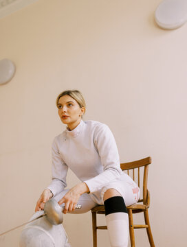 young  blond woman with fencing uniform