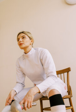 young  blond woman with fencing uniform
