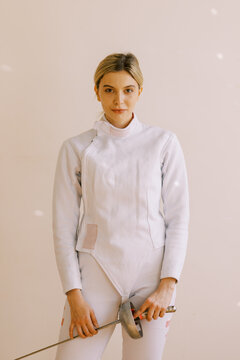 portrait of young woman with fencing uniform
