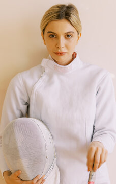 portrait of young woman with fencing uniform