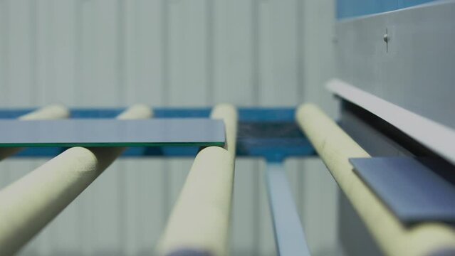 The glass goes into the machine on rollers and goes through the tempering process