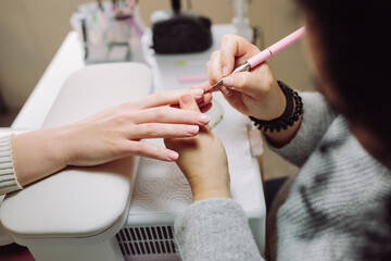 Manicurist painting nails