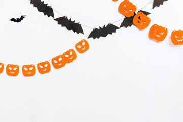 Trick or Treat concept. Holiday composition with halloween garland decorations pumpkins and bats isolated on white background. Preparation for Halloween party. Autumn fall happy Halloween.