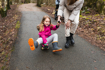 Playful child playing with skateboard