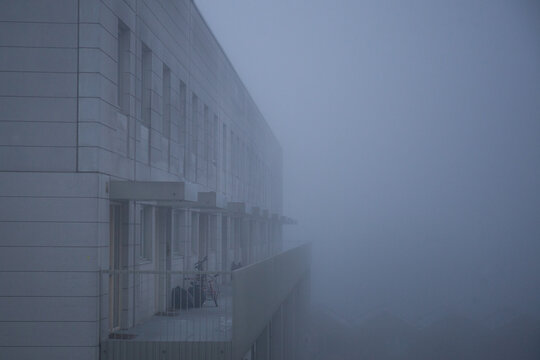 Foggy balcony of flats in urban environment.