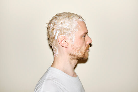 Young man bleaches his hair