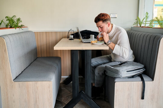 University student enjoying a snack in a cafeteria