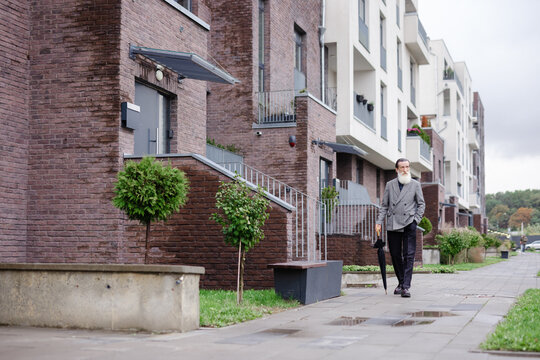 Retiree cityscape stroll condominium style weather leisure street