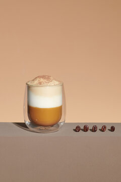 Cafe latte macchiato layered coffee in a see through glass coffee cup.