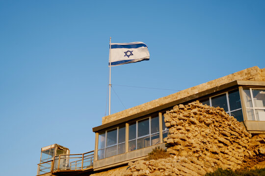 Israel national flag on a background of blue sky
